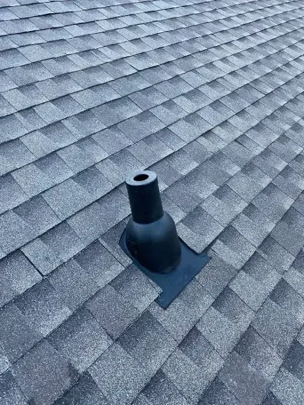 Black rubber pipe boot on gray asphalt shingle roof