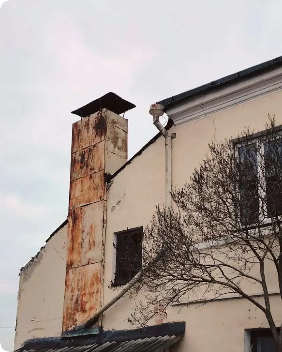 Deteriorating unused chimney showing moisture damage