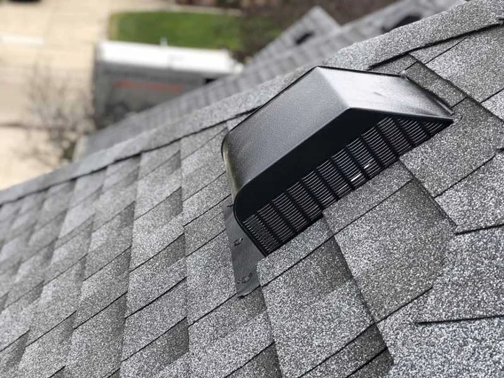 Gray attic ventilation system with black mesh screen