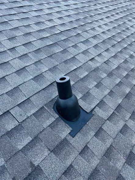 Black rubber pipe boot on gray asphalt shingle roof